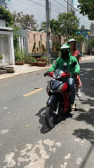 Woman rides Grab motorbike in Đồng Nai, Vietnam