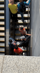 Two men ride escalator in Tel Aviv