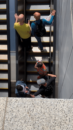 Two men ride escalator in Tel Aviv