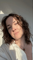 Woman in white shirt photographed in apartment setting