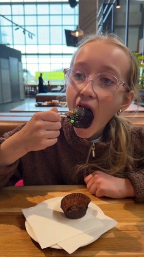 Woman dines at buffet restaurant in Ulbroka, Latvia