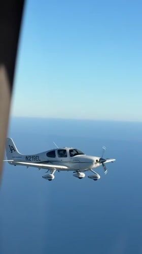 Small plane N219EL cruises over the California coast