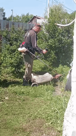 Late-night lawn care work documented in Artyom, Russia
