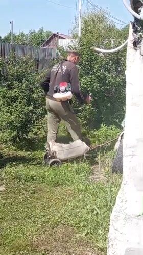 Late-night lawn care work documented in Artyom, Russia