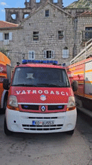 Fire trucks stationed in Perast, Montenegro during quiet afternoon