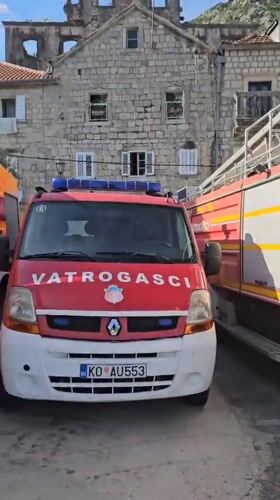 Fire trucks stationed in Perast, Montenegro during quiet afternoon