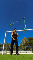 Staff and nunchuck performance on a sunny field in Karaganda