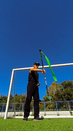 Staff and nunchuck performance on a sunny field in Karaganda