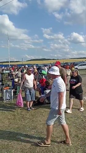 Outdoor gathering with camping gear in a Russian field
