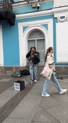 Street performer, pedestrians, security patrol captured near Kazan Cathedral