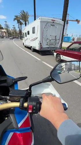 Motorcyclist travels through sunny Tangier streets, Morocco