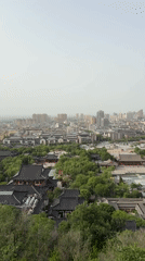 Cable car riders document foggy morning views over Lintong District