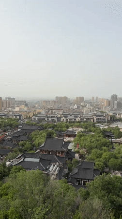 Cable car riders document foggy morning views over Lintong District