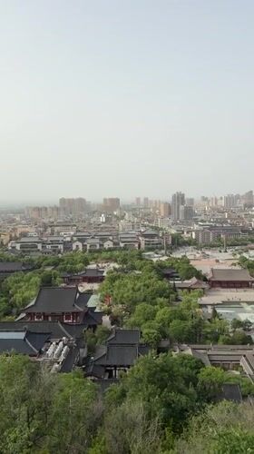 Cable car riders document foggy morning views over Lintong District