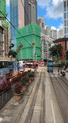 Morning tram operations and pedestrian activity observed in Hong Kong
