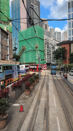 Morning tram operations and pedestrian activity observed in Hong Kong