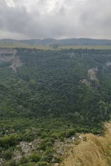 Dashbashi Canyon's steep green walls under a cloudy sky