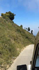Vehicle travels winding hillside road in San José de Galipán