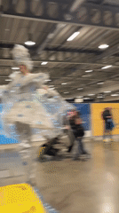 Costumed stilt walker performs in indoor Luxembourg venue