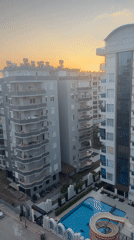 Golden hour footage captures residential cityscape with modern apartment buildings