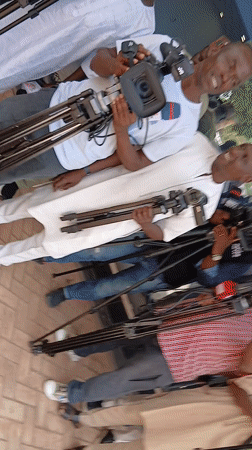 Media crew gathers with equipment in Nigerian courtyard