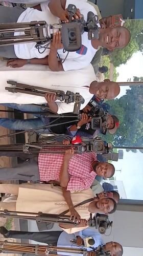 Media crew gathers with equipment in Nigerian courtyard