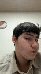 Young man documented indoors during study session with notes
