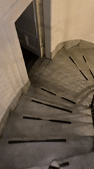 Person descends marble stairs in Buenos Aires building
