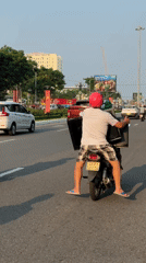 Two-person motorcycle ride captured on Da Nang road