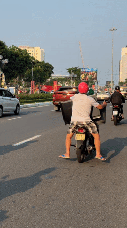 Two-person motorcycle ride captured on Da Nang road