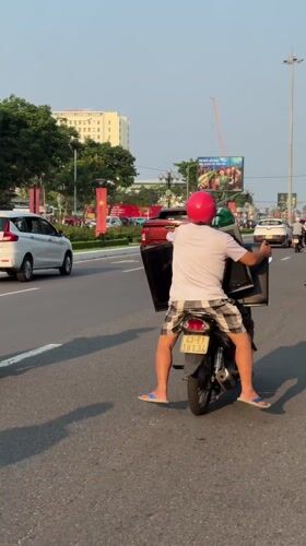 Two-person motorcycle ride captured on Da Nang road