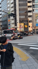 Go-karts navigate busy Shibuya crosswalk amid morning pedestrian traffic