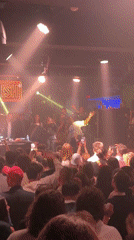 Two women dance on platform at Paris nightclub