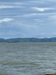 Cargo ship in Avacha Bay, Kamchatka, under dramatic skies
