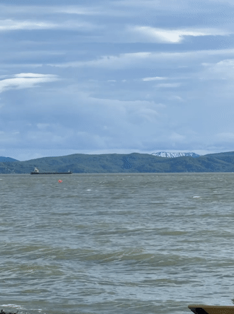 Cargo ship in Avacha Bay, Kamchatka, under dramatic skies