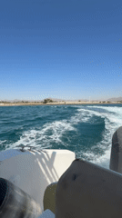 Boat trip documented through turquoise waters near coastal harbor