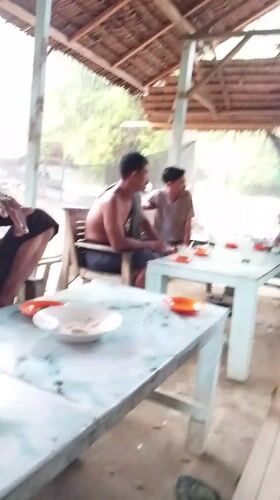 Rural Indonesian community life documented in outdoor gathering spaces