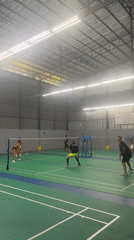 Badminton doubles match at indoor court in Thailand