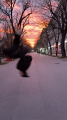 Person performs backflip on Shumen street during sunset