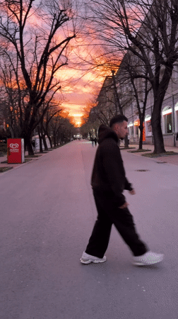 Person performs backflip on Shumen street during sunset
