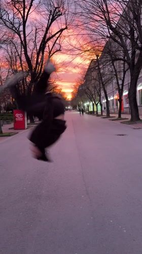 Person performs backflip on Shumen street during sunset