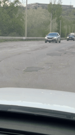 Cracked, potholed road documented in Kamyshin, Russia