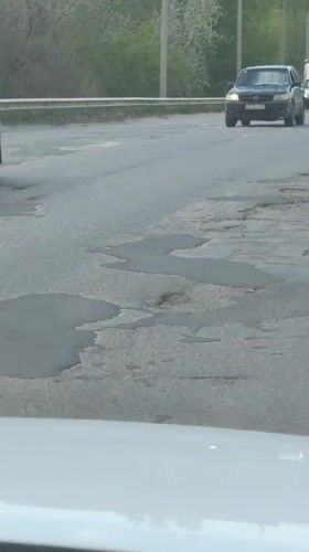 Cracked, potholed road documented in Kamyshin, Russia