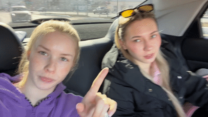 Young women take selfies during car ride in Berezniki