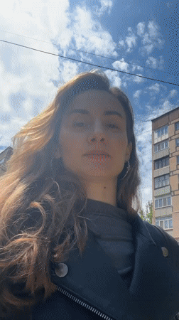 Woman photographing, commuting by bus in Kryvyi Rih morning