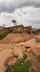 Village life along a rocky, muddy river on a June afternoon