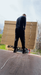 Workers load shipping containers with boxes in Bulgarian industrial facility