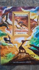 Stamp collector documents Guinea dinosaur and dolphin stamps in Bulgaria