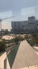 Train passenger films Mexico City skyline with construction activity