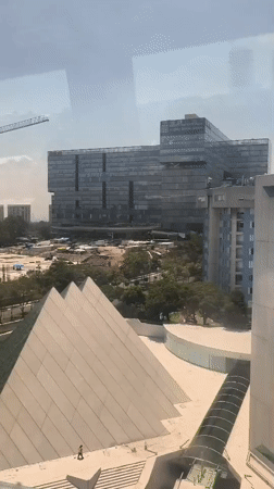 Train passenger films Mexico City skyline with construction activity